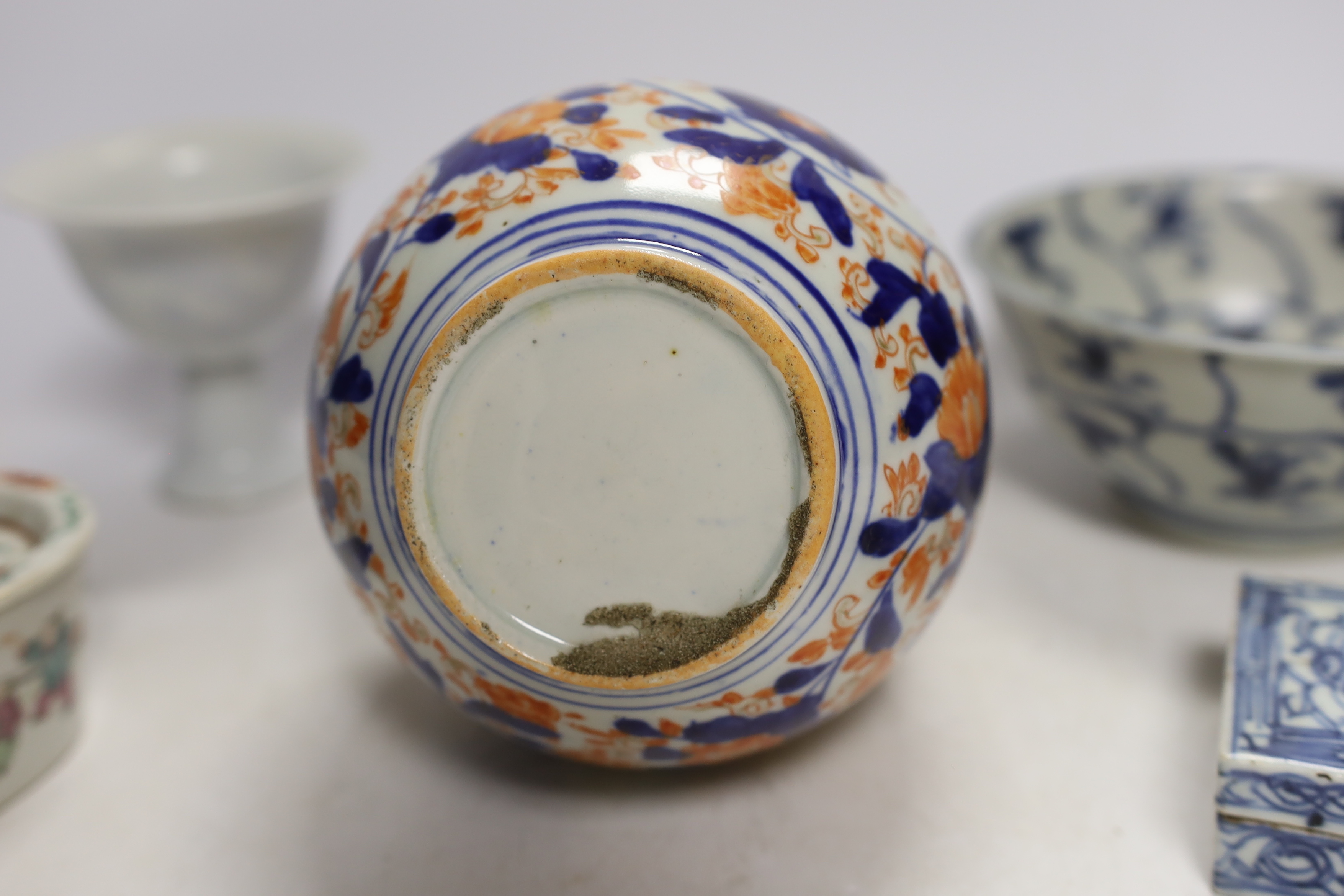 A Chinese Tek Sing Cargo bowl, a Chinese famille Rose Jar and cover, late 19th century, a stem cup with hidden decoration a box and cover and a Japanese Imari bottle vase.